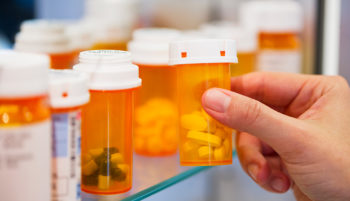 hand picking up prescription drugs