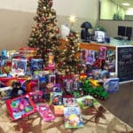 Toys for Tots toys by Christmas tree