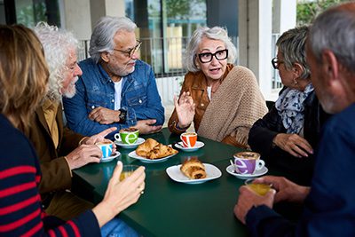 Elderly people socializing over breakfast