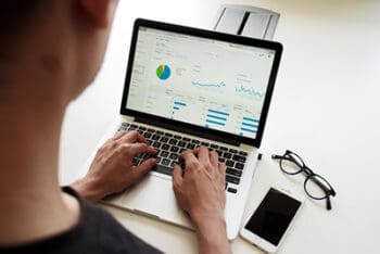 man researching on laptop