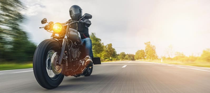 Man riding a motorcycle on an open highway