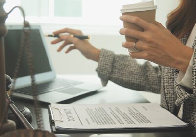 Small business owner by a computer and scales of law